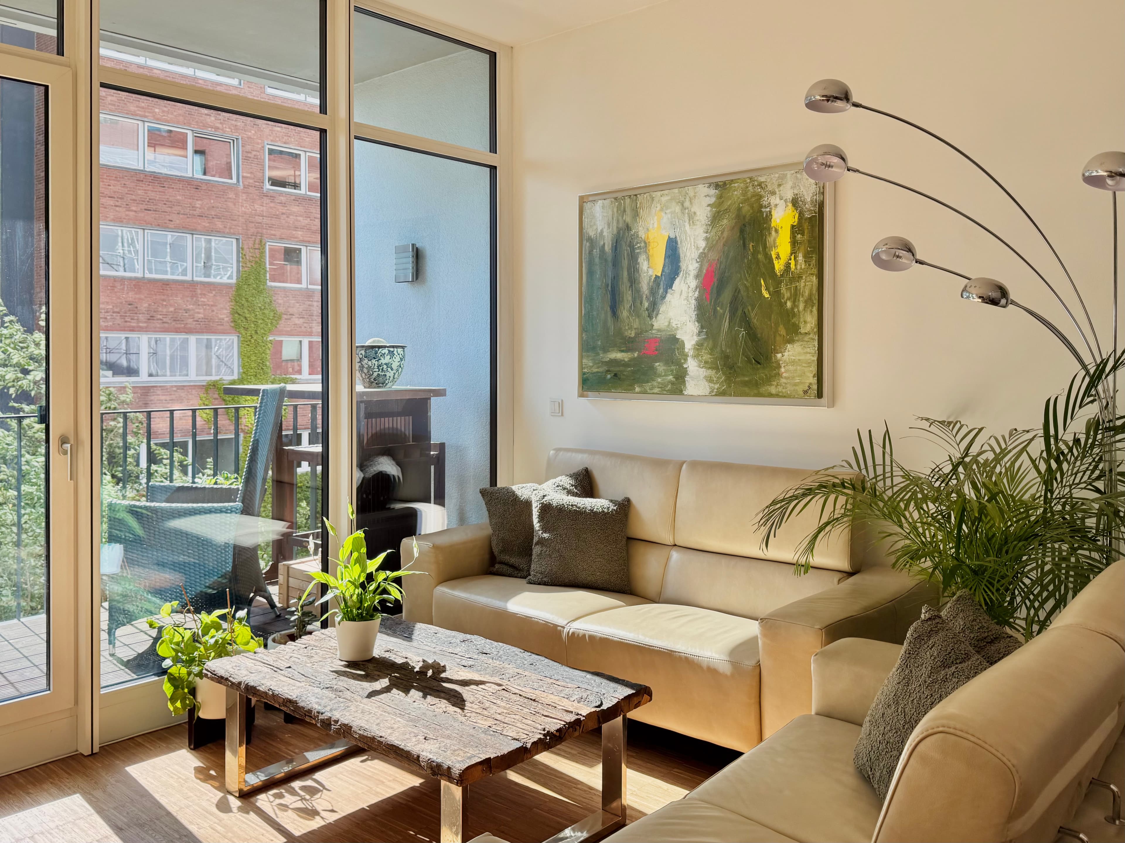 Open-plan living room with floor-to-ceiling windows and loggia access